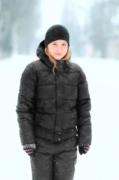 Girl in a black warm suit in the winter Royalty Free Stock Images