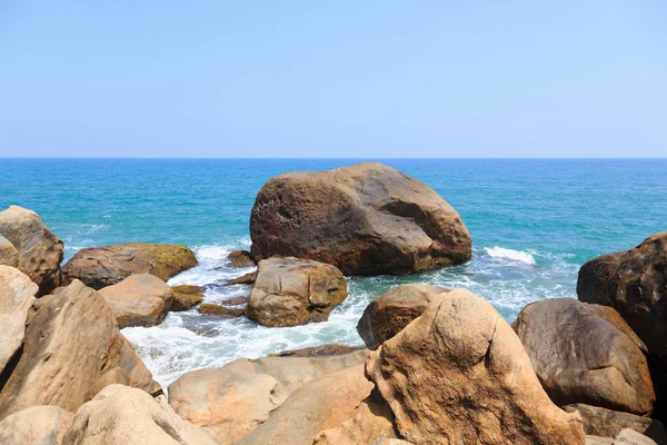 Oceaan golven wassen de rotsen van een tropisch strand — Stockfoto