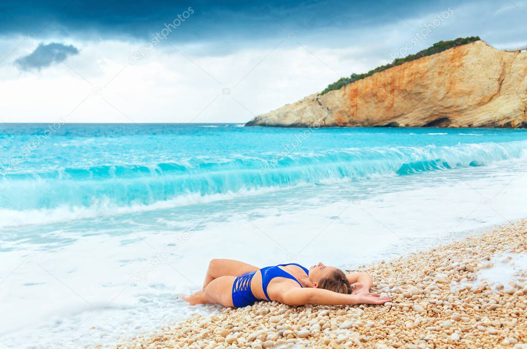 Attractive woman lying on famous beach Porto Katsiki on the Ionian island of Lefkas Greece