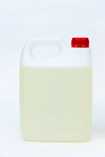 Plastic canister with liquid on white background. — Stock Photo, Image