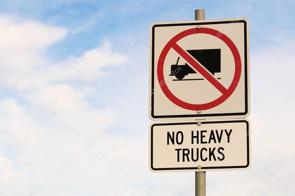 No Heavy Trucks Sign against Cloudy Blue Sky Background