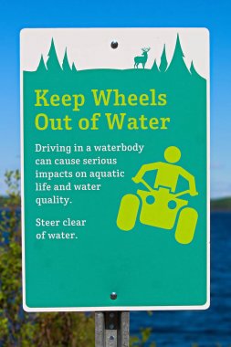 Keep wheels out of water sign along a lakeshore clipart