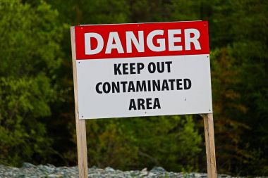 Closeup of a danger keep out of contaminated area sign clipart