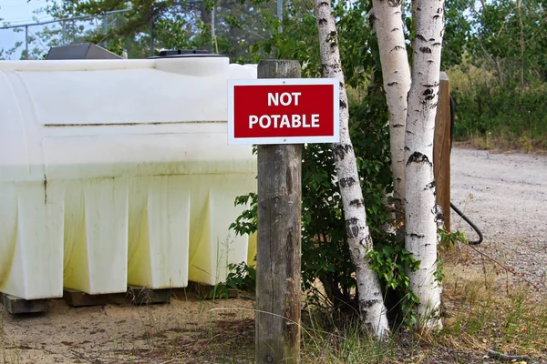 A not potable sign next to a water holding tank — Stock Photo, Image