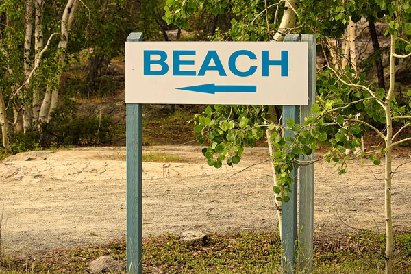 A blue beach sign with a direction arrow Royalty Free Stock Images