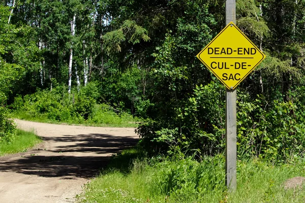 Un panneau d'impasse à côté d'une route de gravier — Photo