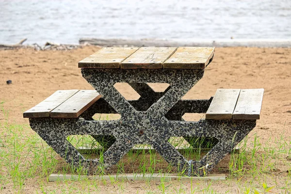 View of a cement picnic table at a beach — Stock Photo, Image