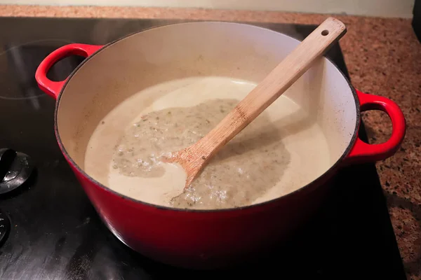 Una olla de cocción de caldo a base de crema en la estufa — Foto de Stock