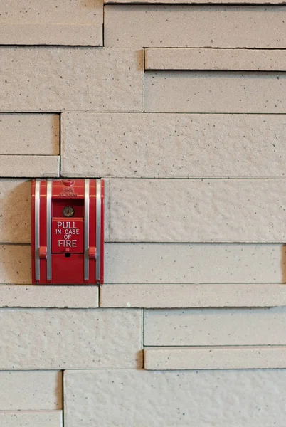 A fire alarm pull box on a wall.