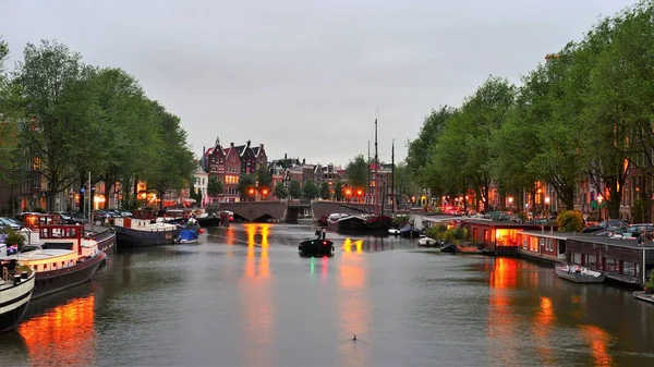 Evening in Amsterdam Boats in the canal of Amsterdam