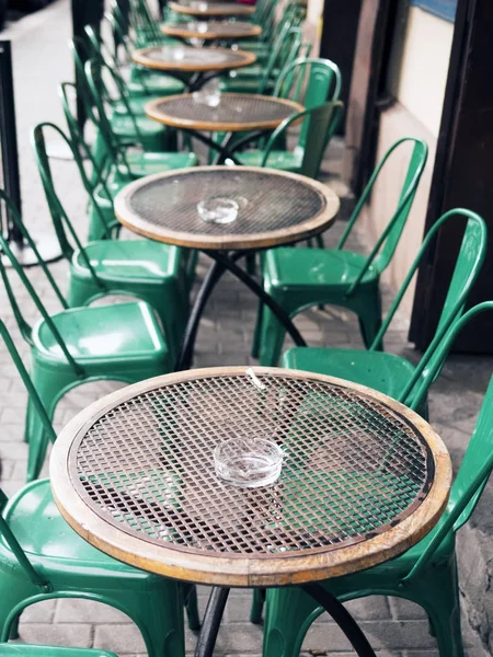 Metal tables and chairs in a street cafe. Loft style