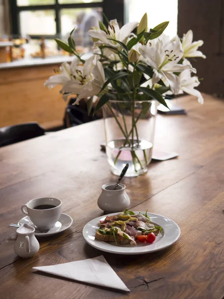 Coffee, milk, sandwich with prosciutto — Stock Photo, Image