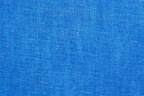 Modrá džínovina pozadí. Bavlněné džíny hadřík textura — Stock fotografie