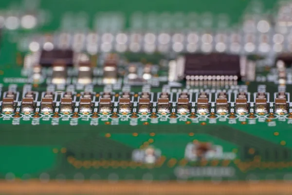 PCB with SMD capacitors close-up. Macro photography of a fragment of the decoder panel tft LCD monitor with installed electronic components. Printed circuit board