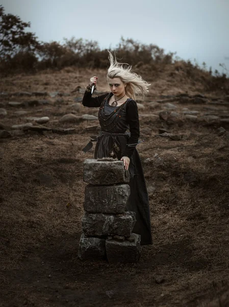 Witch in a long black dress — Stock Photo, Image