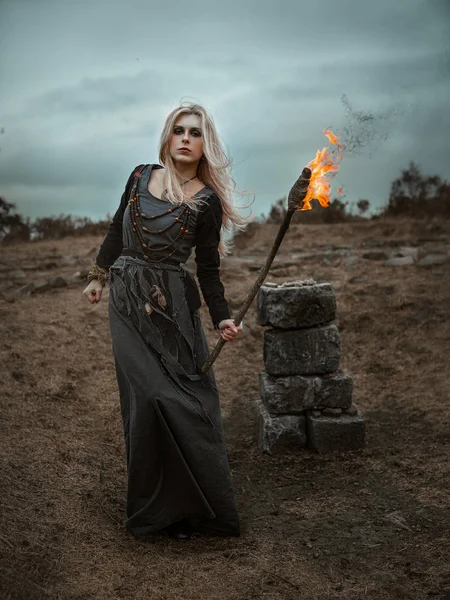 Witch in a long black dress — Stock Photo, Image