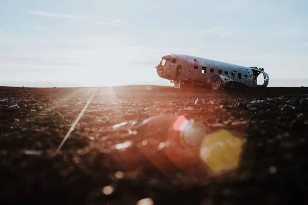 The famous plane wreck in Iceland on a black sand beach at sunset.
