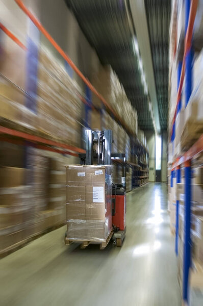 forklift truck moves through the warehouse