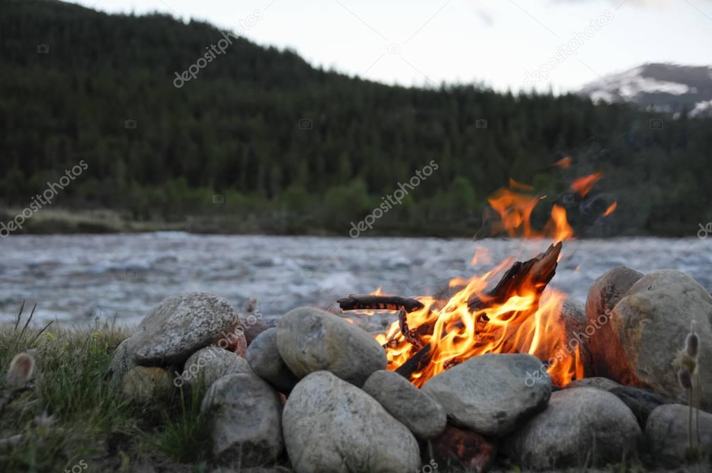 small campfire between rocks