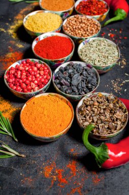 Baharat. Renkli baharat. Köri, safran, zerdeçal, tarçın ve otheron koyu bir beton arka plan. Biber. Farklı baharatlar ve otlar büyük koleksiyonu.