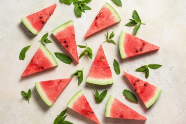 karpuz dilimleri nane ile beyaz beton zemin üzerine bırakır. Taze yaz konsepti. Üstten Görünüm, düz yatıyordu