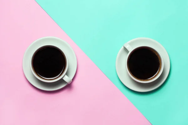 Дві чашки кави на мінімалістичному синьо-рожевому фоні. Вид зверху, плоска лежала. Концепція мінімалізму кави — стокове фото