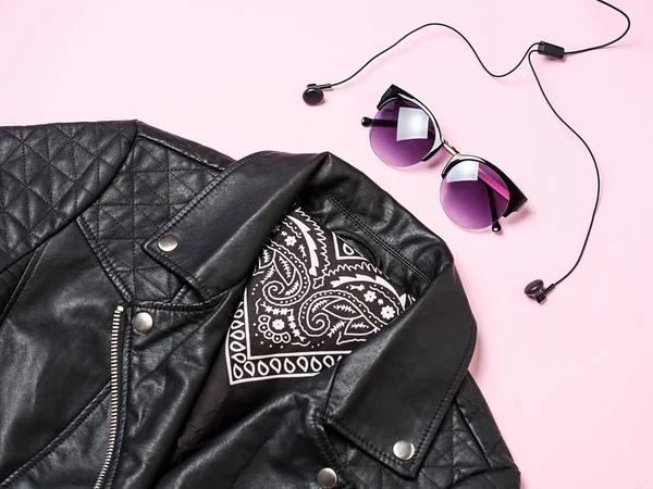 bisikletçinin ceket ve kadın güneş gözlüğü kulaklıklar üzerinde pembe bir arka plan ile. Alternatif moda seti. Düz yatıyordu, en iyi görünümü