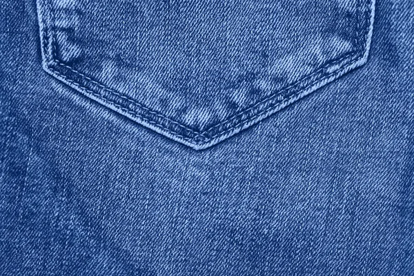 Stack of jeans on table. Classic Blue color. 2020 — Stock Photo, Image