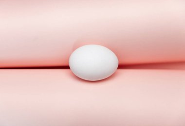 Beyaz yumurtalı yaratıcı Paskalya bej ve pembe arka plan. Paskalya tatili minimum konsept.