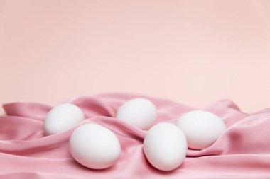 Beyaz yumurtalı yaratıcı Paskalya bej ve pembe arka plan. Paskalya tatili minimum konsept.