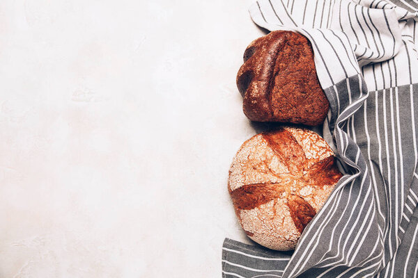 Different kinds of bread on white backdround. Top view, flat lay.