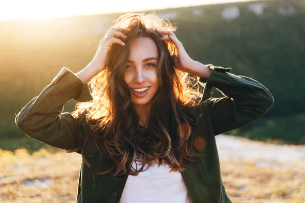 Beautiful sexy young woman smiling on beautiful landscape in sunset time. Happy lifestyle picture.