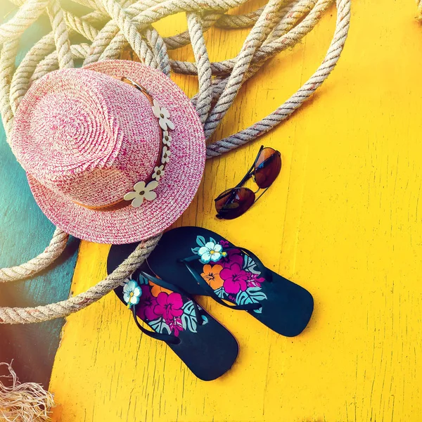 Set of Womans Things Accessories to Beach Season Straw Beach Womans Hat Top View Yellow Background Flat Single