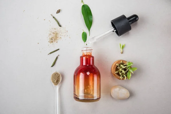 Minimal style. Natural cosmetics, handmade skin and body care. Orange bottle with peep and plants. Flat lay — Stock Photo, Image