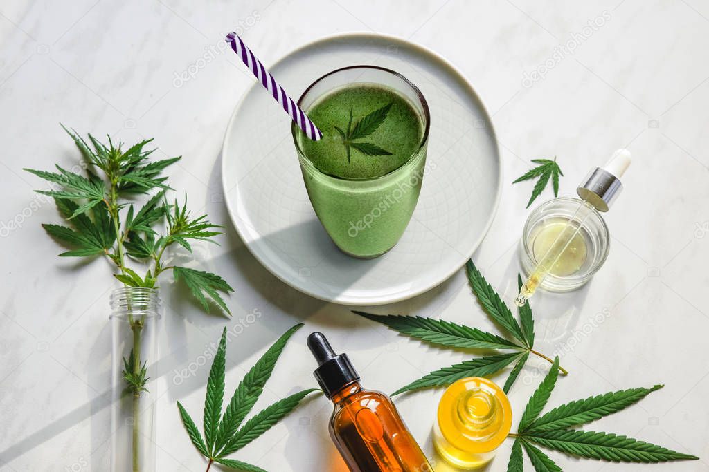 Concept edibles CBD and drinks with cannabis . Glasses with fresh beverage, smoothies, with hemp. Flat lay