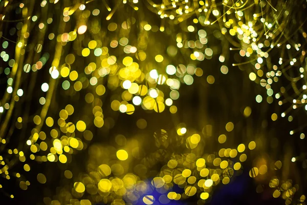 Abstracte wazige gouden sprankelende bokeh achtergrond. Donkere achtergrond Feestelijke kerst achtergrond. Feestfeest — Stockfoto