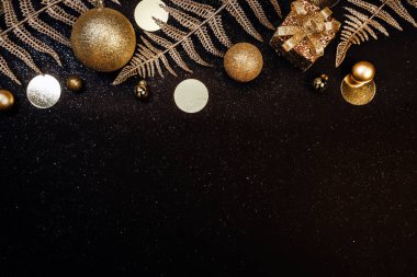Christmas background. Holiday Gifts in white boxes with a festive decor and shiny branches on a black background with glitters. Flat lay, top view, copy space clipart