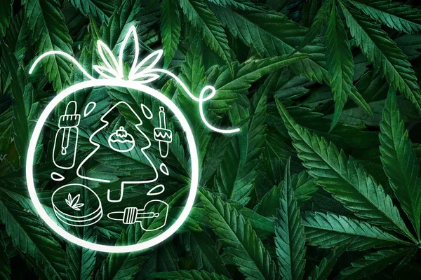 Kreativ jul bakgrund från hampa blad, marijuana och en neon underteckna jul leksak. Platt äggläggning — Stockfoto