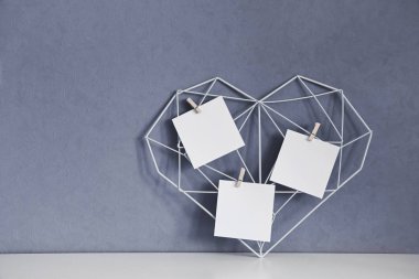 Duvarın arka planında notları olan zarif bir açık kalp. Minimalizm. Aşkın ve Sevgililer Günü 'nün sembolü. Ev Dekorasyonu