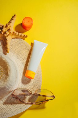 Sunscreen. Straw hat with sun glasses, protection cream SPF Beach accessories. Summer Travel Concept