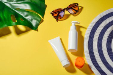 Sunprotection objects, Sanscreen. Hat with sunglasses and protection cream SPF Beach accessories. Summer Travel Vacation Concept