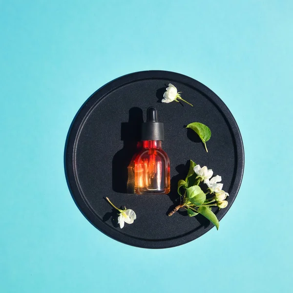 Serum, elixir, perfume for beauty flat lay on blue background. Concept of natural organic cosmetics. Minimalism — Stock Photo, Image