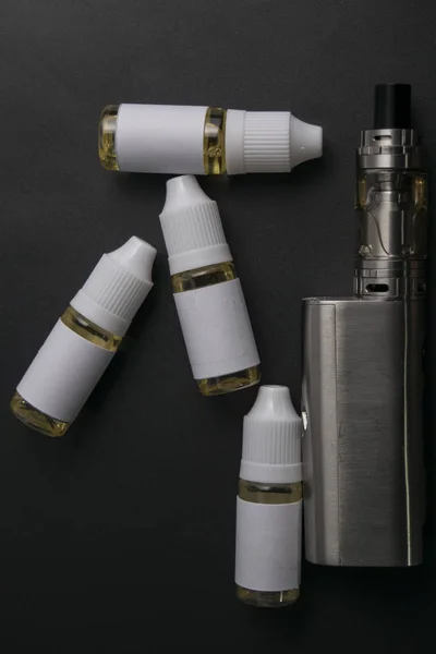 Isolated vaping bottles on a dark background. — Stock Photo, Image