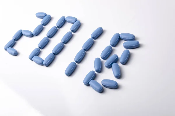 Creative 2018 new year concept made out blue medical tablets ove — Stock Photo, Image