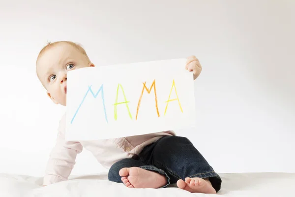 Funny infant kid looking out for poster with sign Mama. Awesome toddler boy holding big postcard for Mothers day — Stock Photo, Image