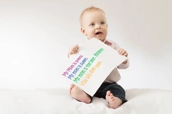 Funny kid with the big postcard. Mothers day greetings. Poster with sign — Stock Photo, Image