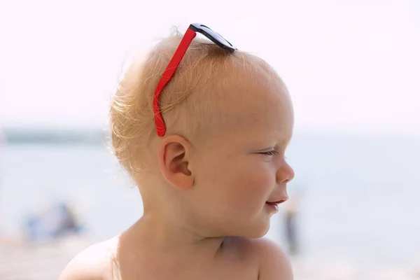 Schattige babyjongen met zonnebril op zijn hoofd. — Stockfoto