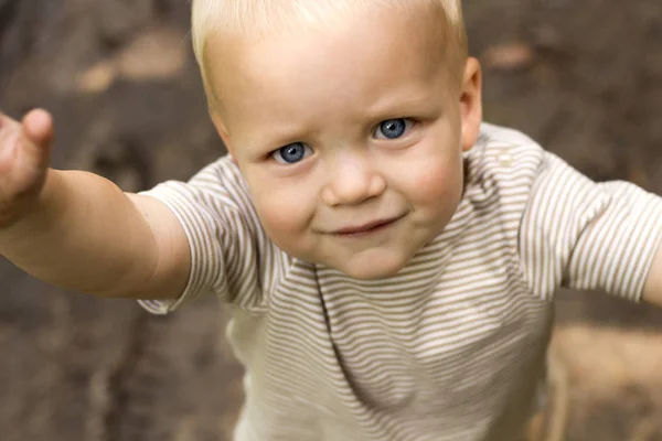 Cute blue-eyed tired baby boy wants to hug — Stock Photo, Image