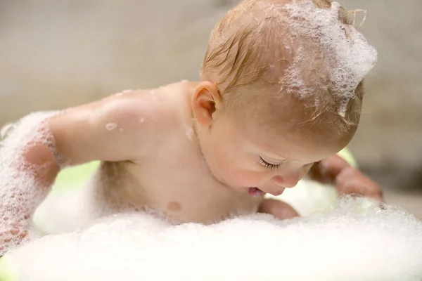 Chłopiec dziecko grając z baniek mydlanych w wannie — Zdjęcie stockowe