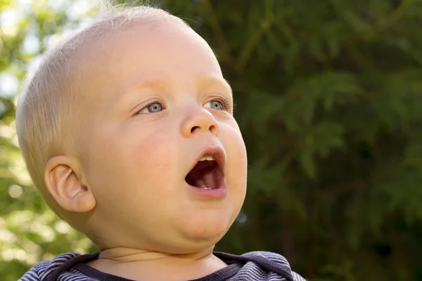 Close up portrait of funny blonde singing toddler. Outdoor shot — Stock Photo, Image